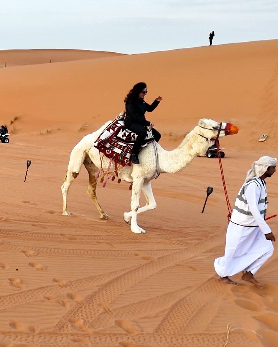 A guest on a guided camel ride across the dunes near Riyadh